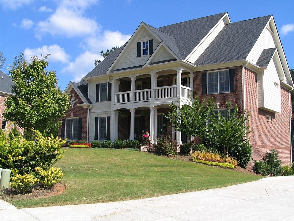 Stately 5Br/4Ba FOUR SIDES BRICK home has the most beautiful lake lot!