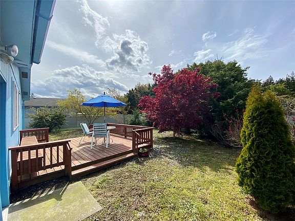Large private backyard with deck.