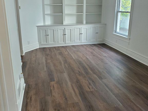 Living Room with built in Bookshelves and new vinyl flooring