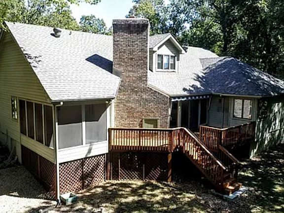 Back of home w/large screen porch & deck