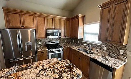 Gorgeous granite counter tops and stainless-steel appliances.