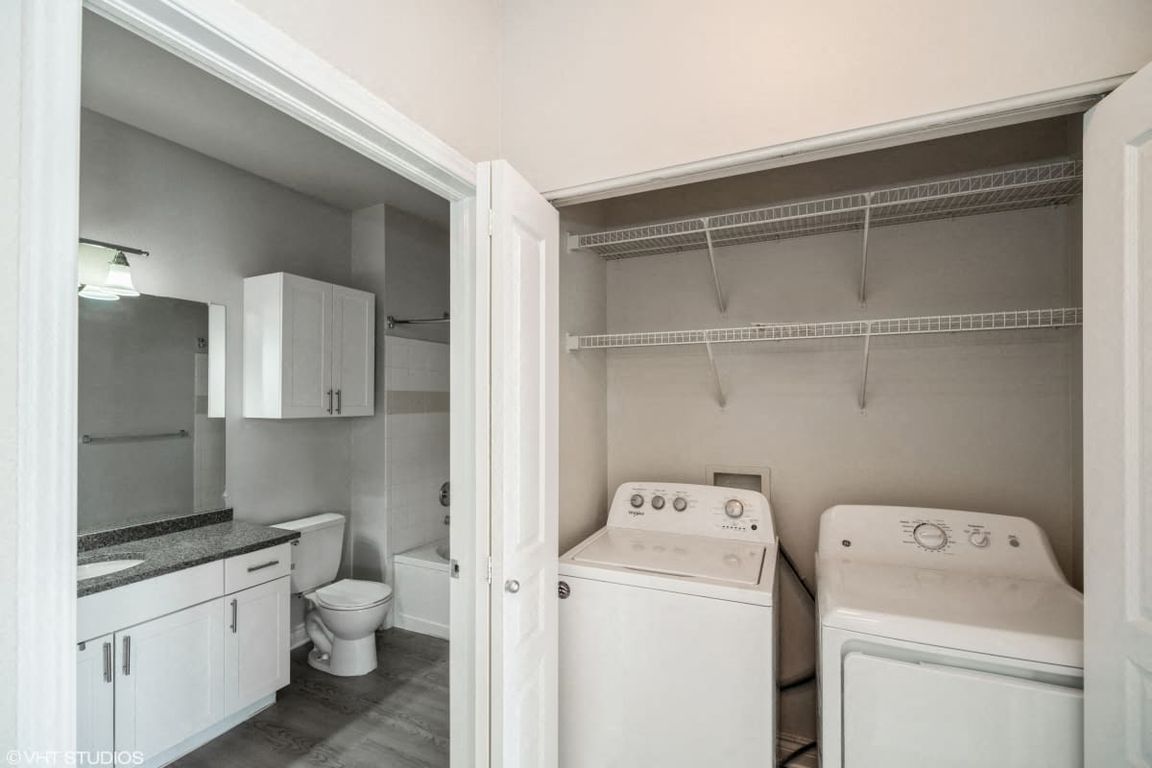 In unit laundry room with washer and dryer