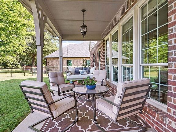 beautiful back patio, peaceful view of mature trees, back yard, and golf course