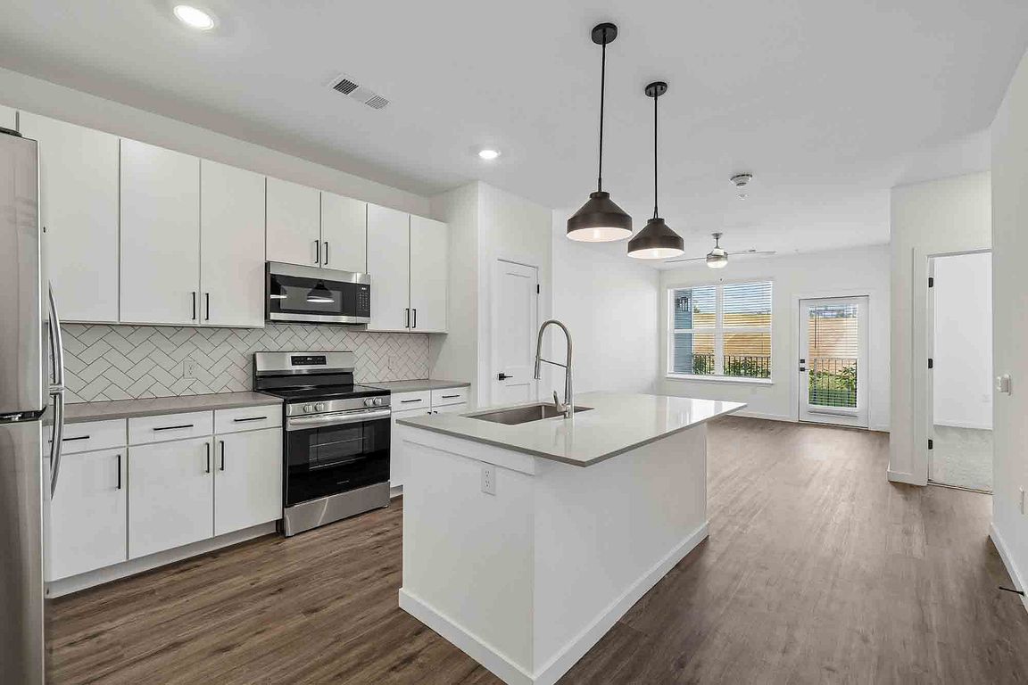The A1's kitchen island faces the living area and opens onto a private patio, so cooking never means turning your back on the room.