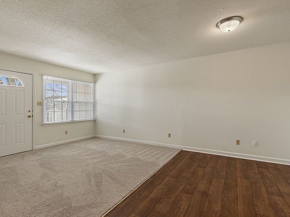 Shamrock living room with hardwood flooring and bright, expansive windows