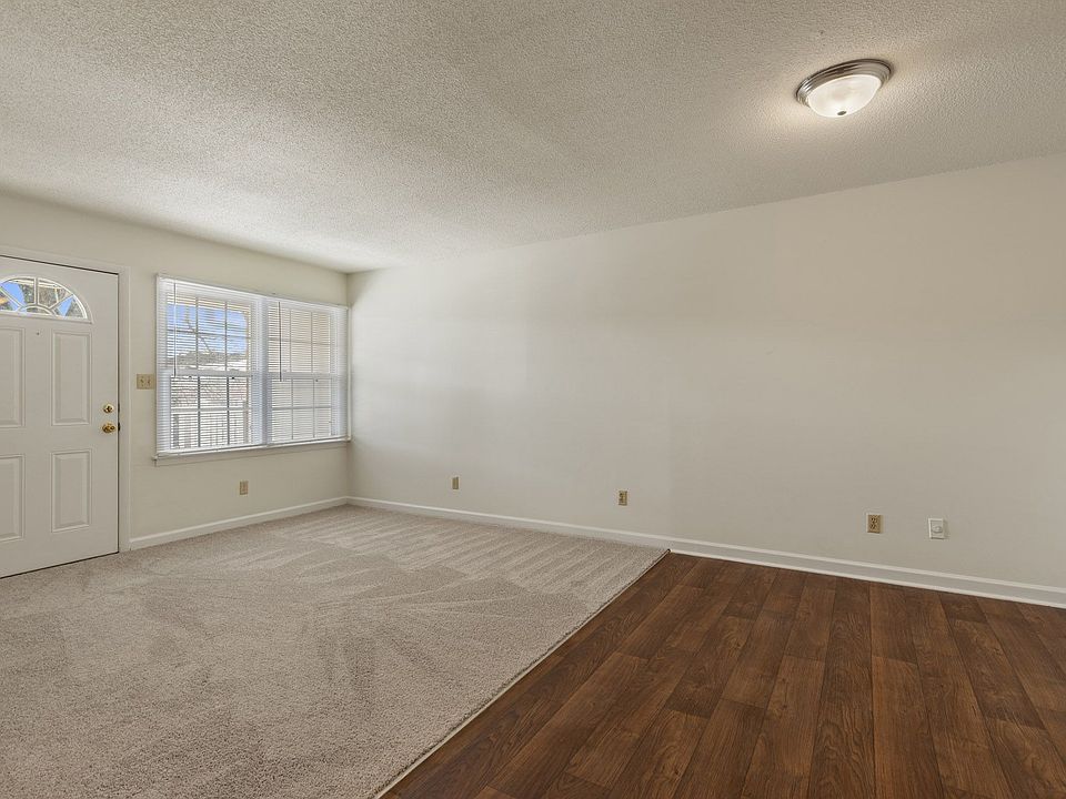 Shamrock living room with hardwood flooring and bright, expansive windows