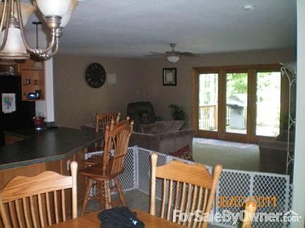 dining looking into the living room. just outside french doors is a huge deck.