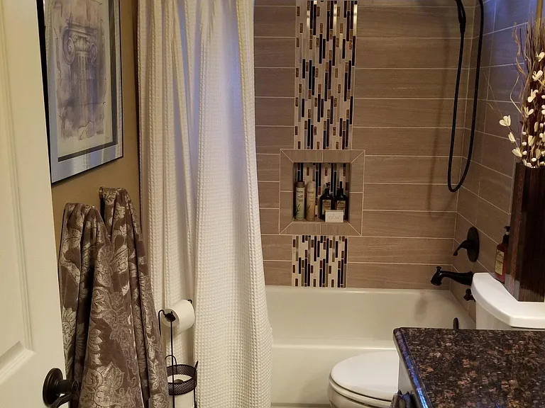 Hall bath, one sink, tub/shower combo, tile floor