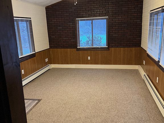 Back bedroom with backdoor leading to side yard, HUGE backyard with firepit.