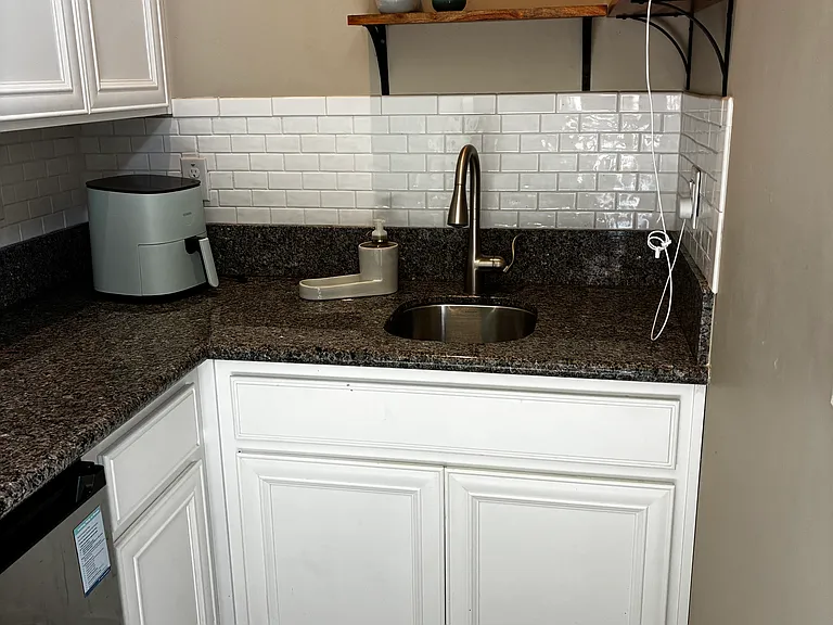 Kitchenette - Mini fridge, sink, cabinets, garbage disposal, microwave, coffee maker