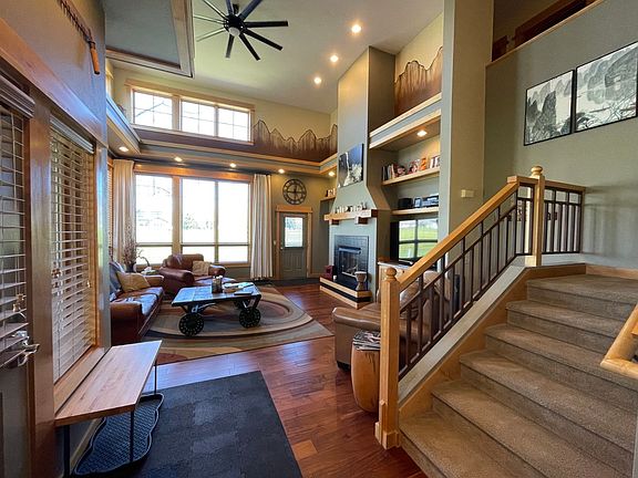 Front door, living room, and staircase. The Bridger Mountains are the main view from the picture windows and the back patio.
