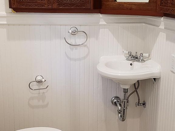 Bath with hand crafted cabinets, clawfoot tub and all new fixtures.