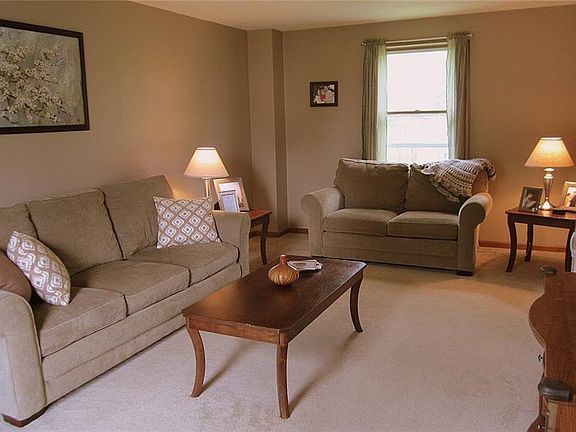The front-to-back Living Room has been freshly painted, boasts new plush carpeting, and a neutral dcor.