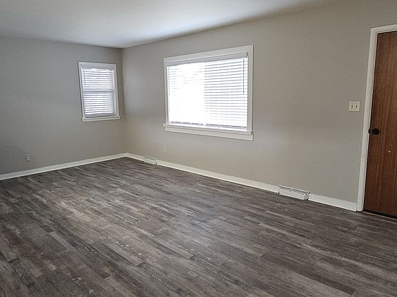 Living Room with a built in bookcase and pass-through to the kitchen.