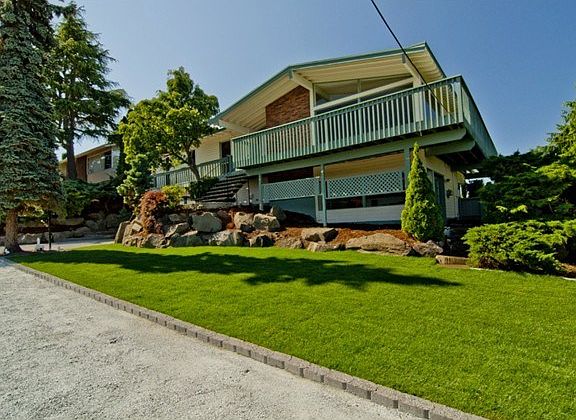 Vintage 1969 Genesee Hill home features wrap around deck to take