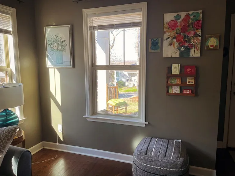 View from front room. North facing porch with several chairs.