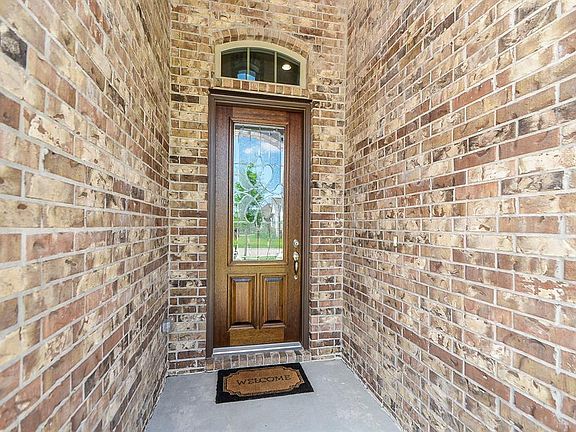 Masterful design and modern luxury are uniquely embodied in this home with features like rough hewn brick facade and beveled glass front door.
