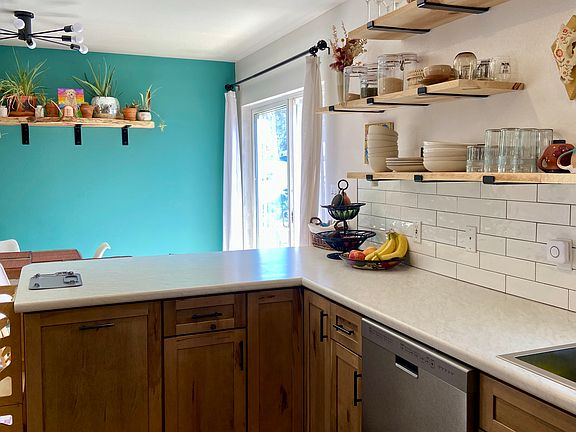 View from the kitchen into the dining. The deck is off of the dining room