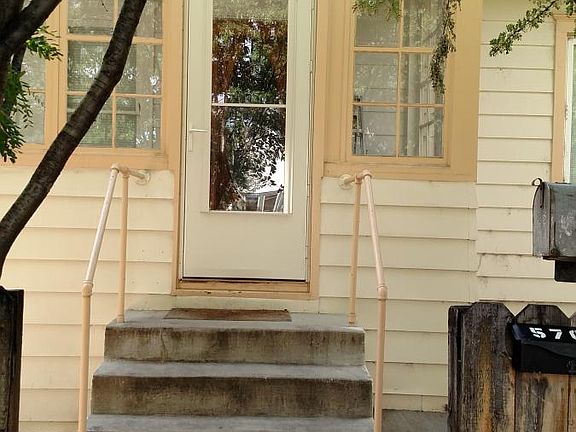 Front of house, entrance to apartment is to the left of the main door.