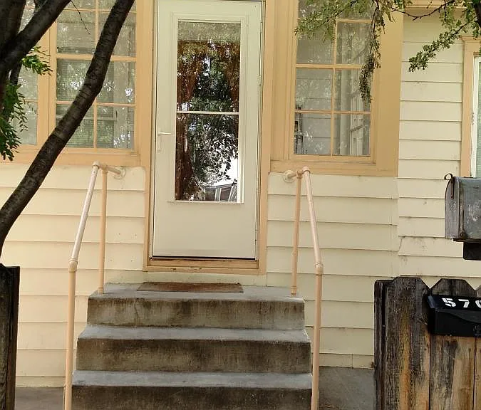 Front of house, entrance to apartment is to the left of the main door.