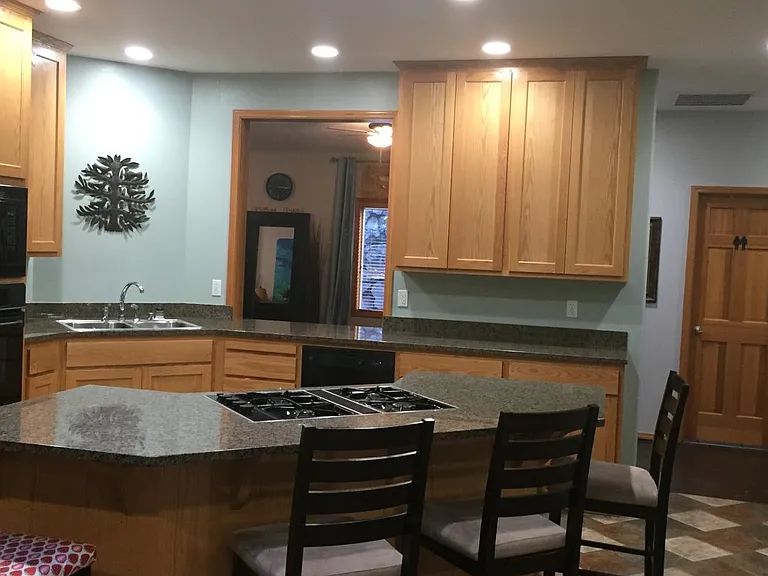 Kitchen. Slab granite, solid wood cabinets that extend the