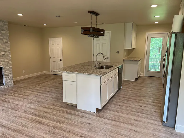 Chef's kitchen with oversized island, stainless appliances, and walk-in pantry _ perfect for cooking and entertaining.