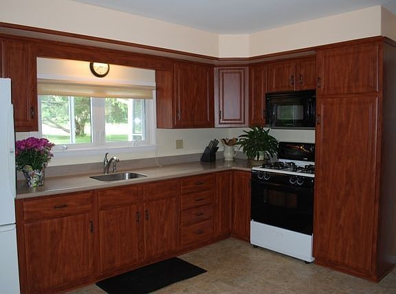 Kitchen W/ Corian Countertops and Cherry Cabinets