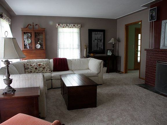 A slate entry leads into a formal livingroom and wood fireplace.