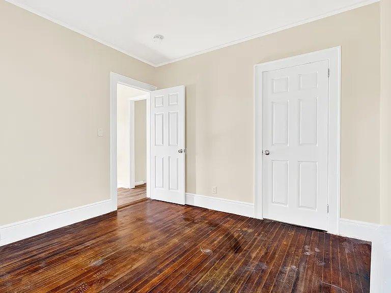 Bedroom with hardwood floors.