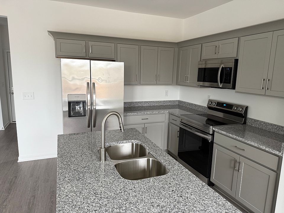 Open kitchen space with new stainless stellar appliances.