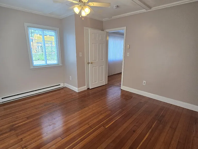 Back bathroom with closet behind entry door