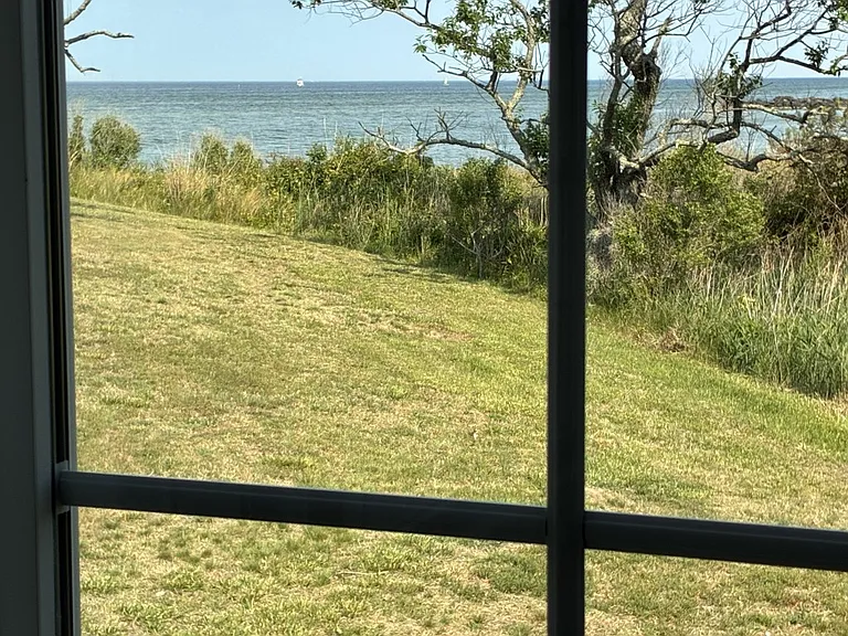 View of boats on water from living room