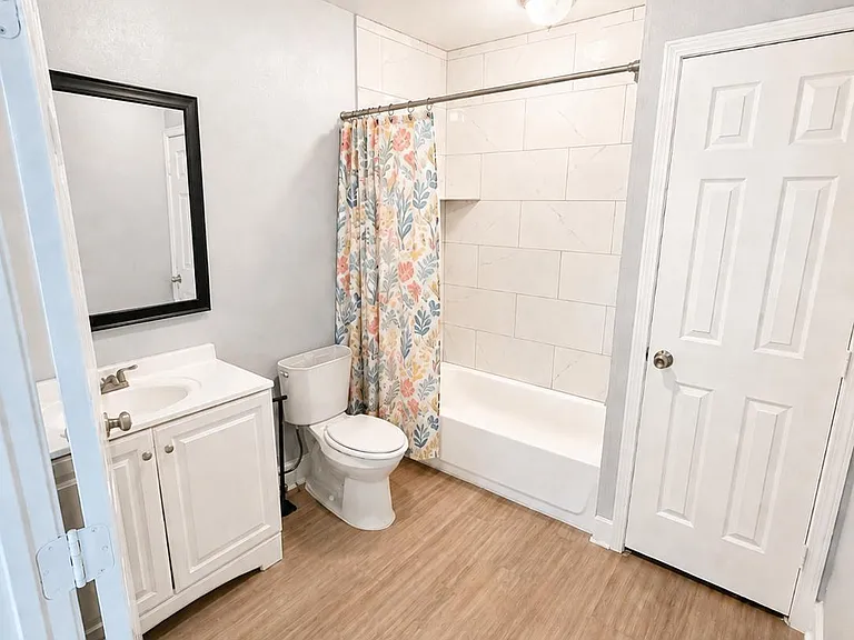 Full bath with tub/shower combo, tiled surround, vanity with storage, and easy-care flooring for daily convenience.