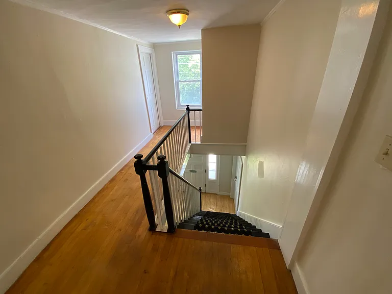 Hallway on second floor and staircase leading up from front entry.