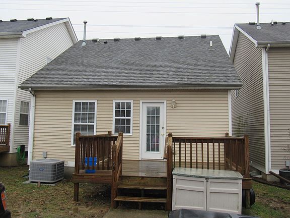 Back of home with deck and storage bin. 2 car off street parking! Also new HVAC unit to, once again, help energy costs and reduce the risk of headache!