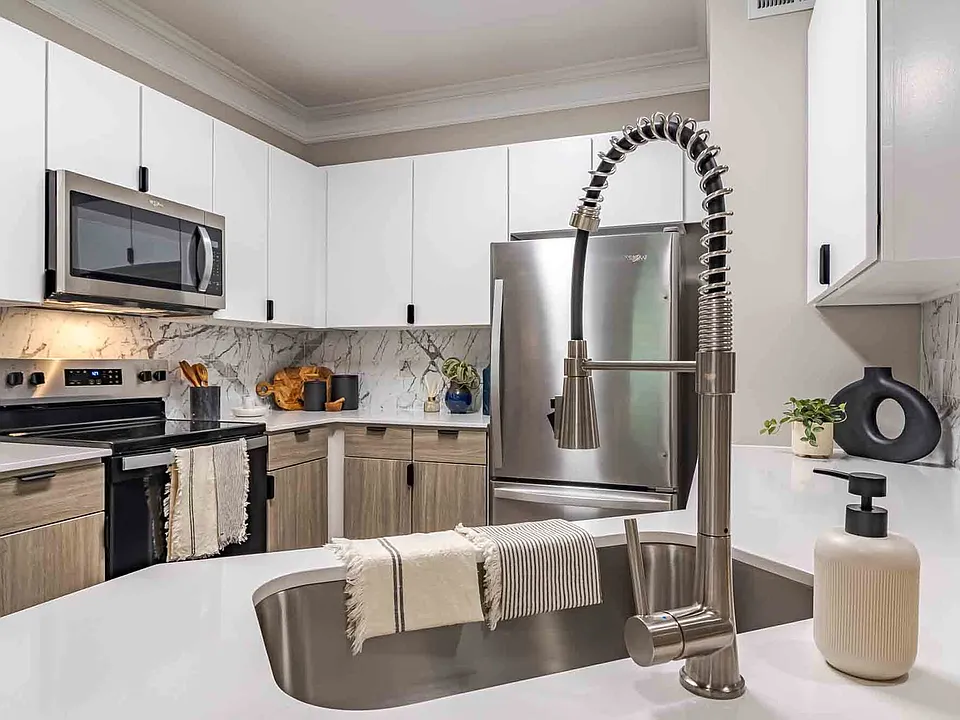 Newly renovated kitchen with quartz countertops, stainless steel appliances and two toned cabinets