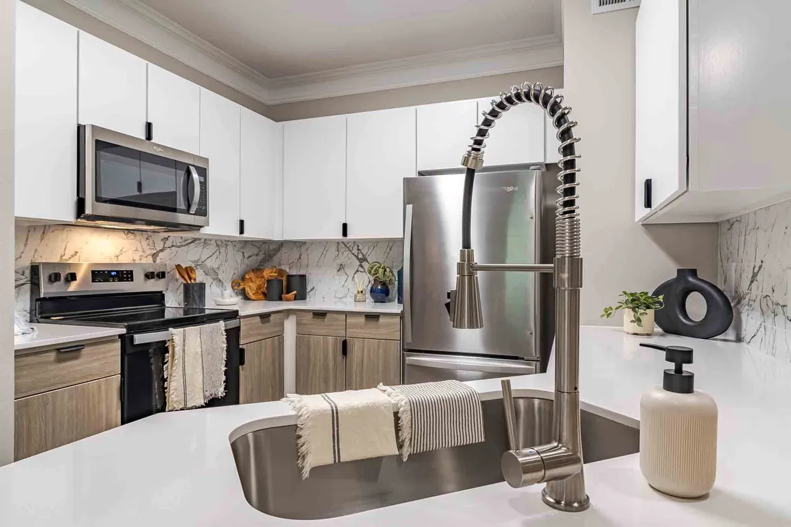 Newly renovated kitchen with quartz countertops, stainless steel appliances and two toned cabinets