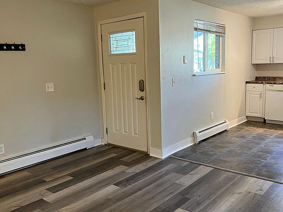 View from living room corner of entryway. New tile in kitchen and vinyl plank hardwood throughout all upstairs.