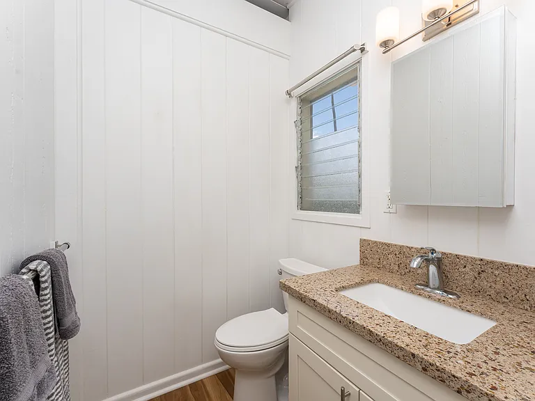 Studio bathroom featuring an updated vanity and a separate shower area (not pictured).