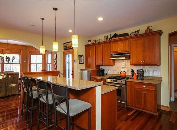 The kitchen has it all with a large island, pantry, adjacent dining plus walk out to the screen porch and backyard. There is a mudroom and convenient access to the 3 car garage.
