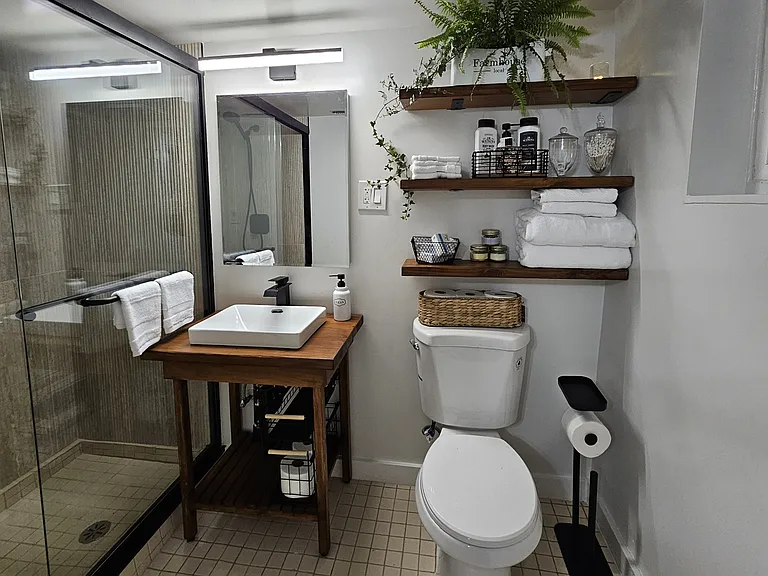 Custom built vanity and floating shelves staged for suggested use