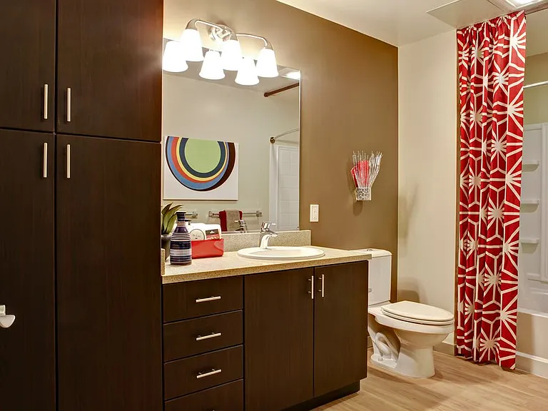 Classic Package I bath with grey speckled granite countertop, espresso cabinetry, and hard surface flooring