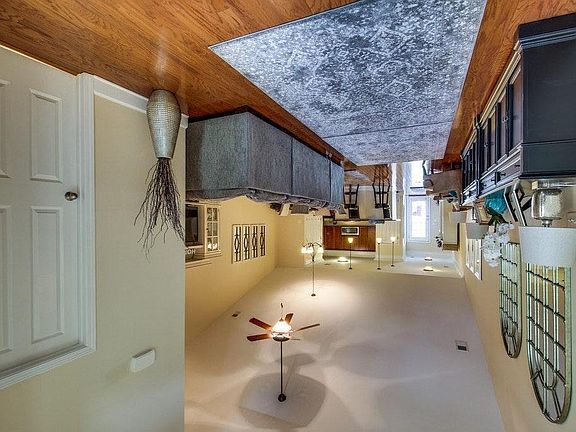 Open floor living with high vaulted ceilings, view from entrance