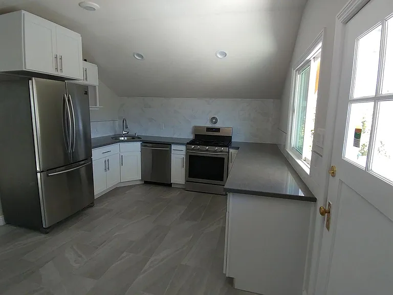 Beautifully laid out gourmet kitchen with all new appliances, cabinets, countertops, and porcelain floors with access to your own private patio.