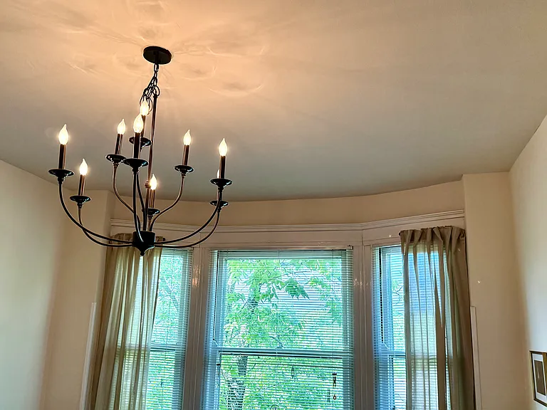 The dining room has a beautiful bay window and also new chandelier.