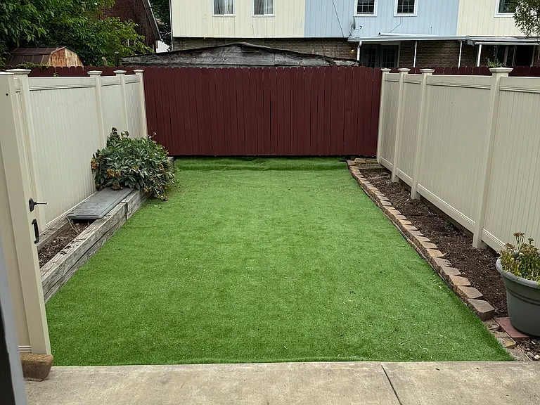 Fake grass maintenance free private back yard