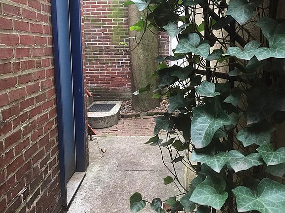 Walkway to apartment, door to garage on left.