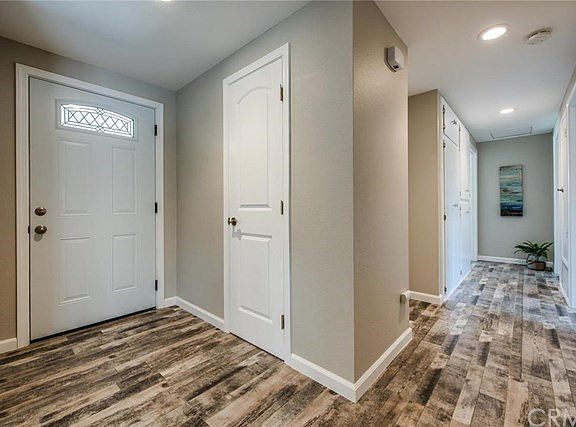 FRONT DOOR ENTRY VIEW. INTERIOR HAS BEEN BEAUTIFULLY REMODELED! NEW FLOORING, DOORS, RECESSED LIGHTI