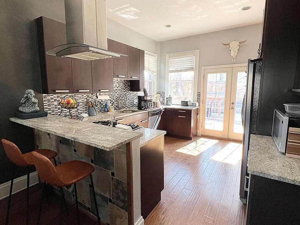 The beautiful kitchen features stainless steel appliances and a gas range.