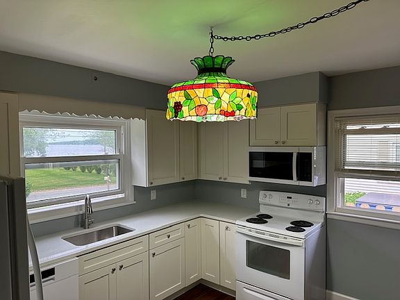 Kitchen with new appliances and quartz counters.